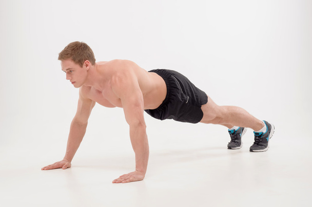 Guy making push ups exercise - Фото, зображення