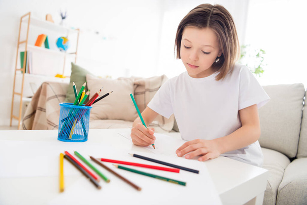 Photo of young attractive school girl concentrated focused moody paint picture pencil sit couch home - Foto, immagini