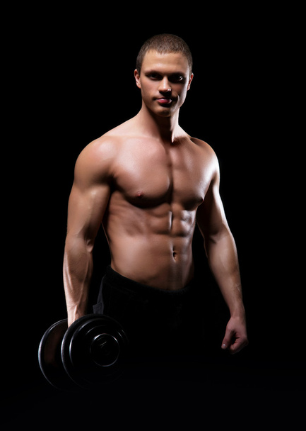 Bodybuilder man with a dumbbell - Photo, Image