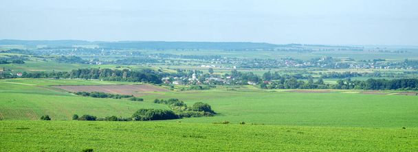 Beautiful panorama of agricultural fields and hills on a summer day - Foto, imagen