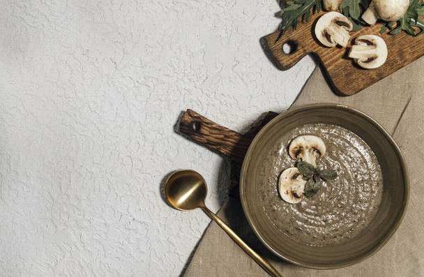 porridge with mushrooms and arugula on wooden board - 写真・画像