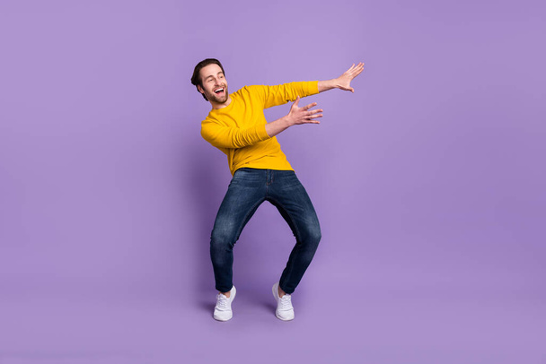 Full length body size view of attractive cheerful man dancing moving rest having fun isolated over pastel violet purple color background - 写真・画像