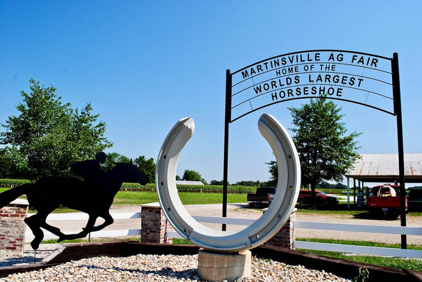 Martinsville, Illinois: Worlds largest horseshoe in front of Martinsville Agricultural Fairgrounds. Silhouette of horse rider. Martinsville is home to the Great Midwest Trot and Pace. - Photo, Image