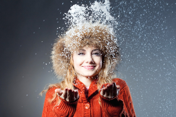 Young beautiful girl rejoices to snow - 写真・画像