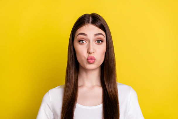 Photo of young lovely girl pouted lips send air kiss flirty romantic love isolated over yellow color background - Foto, Imagen
