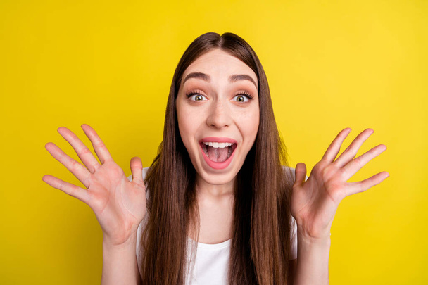 Photo portrait of woman staring amazed shouting loud isolated vibrant yellow color background - 写真・画像