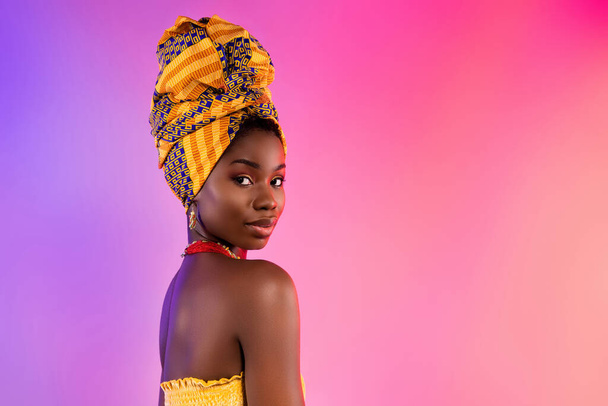 Photo of charming stunning dark skin woman wear traditional clothes serious face isolated on vivid gradient background - Foto, afbeelding