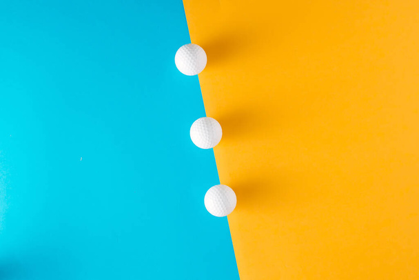 Abstact concept with white balls on blue and yellow background. Minimal lay out arrangement. - Fotoğraf, Görsel