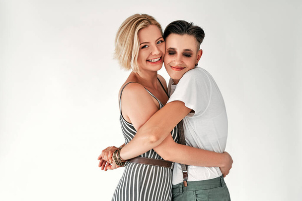 Lesbian couple embracing each other on white background. Equality right, homosexuality lifestyle, lgbt, and relationship concept. Copy space. - Photo, image
