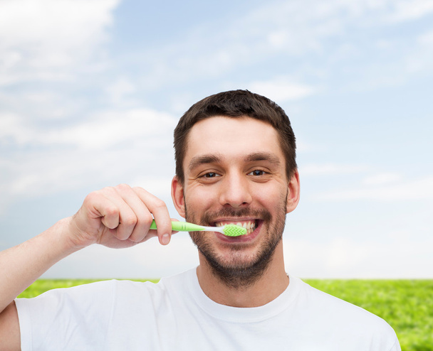 smiling young man with toothbrush - Foto, Imagem