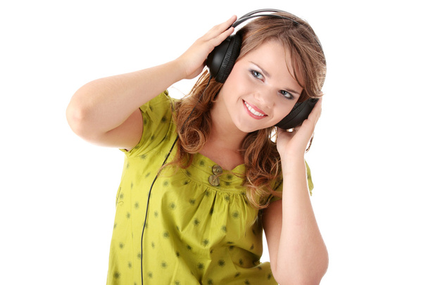 Beautiful teenage girl listening to music - Photo, image