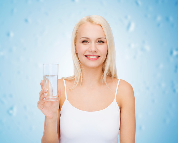 young smiling woman with glass of water - Photo, Image