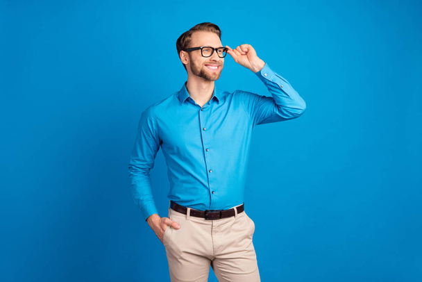 Photo of young handsome man happy positive smile look empty space dream isolated over blue color background - Photo, image