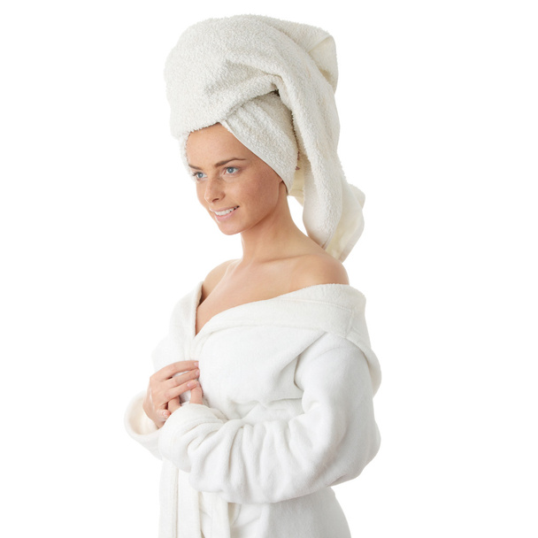 Portrait of 20-25 years old beautiful woman wearing bathrobe, isolated on white - Foto, afbeelding