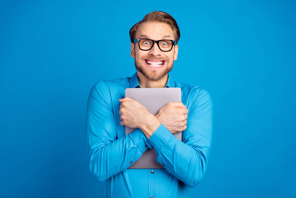 Photo of young excited man hug cuddle embrace laptop happy positive toothy smile isolated over blue color background - Photo, image