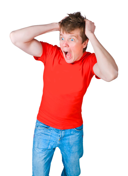 shocked and frightened young man in a red T-shirt - Foto, Imagen