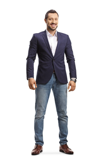 Full length portrait of a man in jeans and suit standing and smiling isolated on white background - Foto, afbeelding