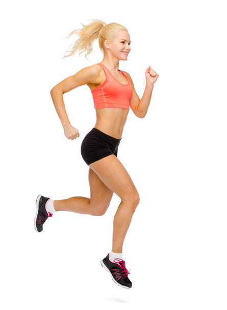 sporty woman running or jumping - Foto, Imagen