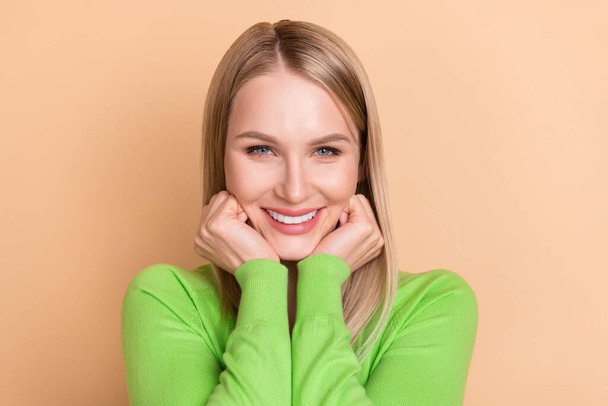 Portret van aantrekkelijke blonde vrolijke meisje manager genieten van goed humeur geïsoleerd over beige pastel kleur achtergrond - Foto, afbeelding