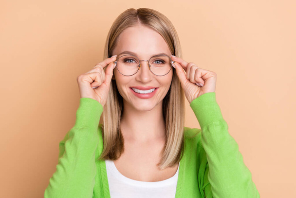 Portrait of attractive cheerful experienced girl librarian touching specs isolated over beige pastel color background - Fotó, kép