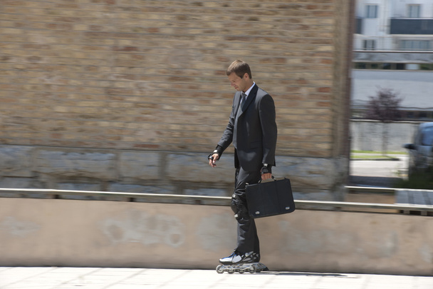 Businessman rollerblading - Фото, зображення
