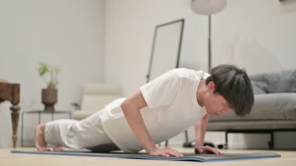 Tired Asian Man doing Pushups on Yoga Mat at Home - Video