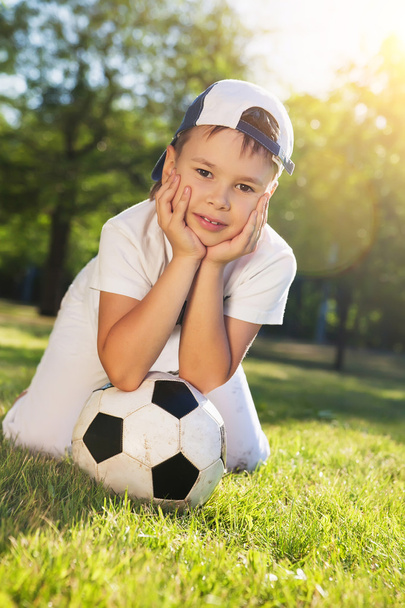 Cute little boy with a ball in beautiful park in nature; - Foto, Imagen