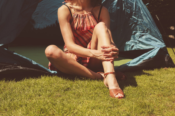 Young woman sitting in a tent  - Φωτογραφία, εικόνα