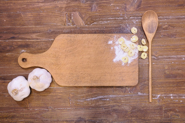 Cutting board with tortellini. - Фото, изображение