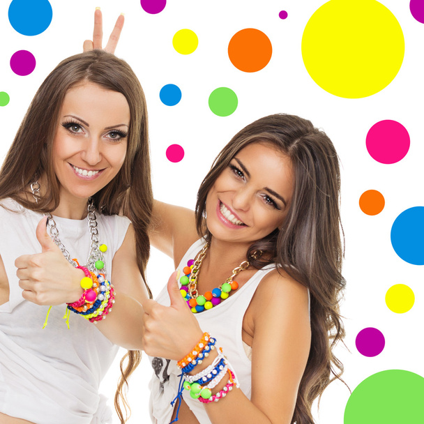 Two young women with fashionable colorful jewelry - Fotoğraf, Görsel
