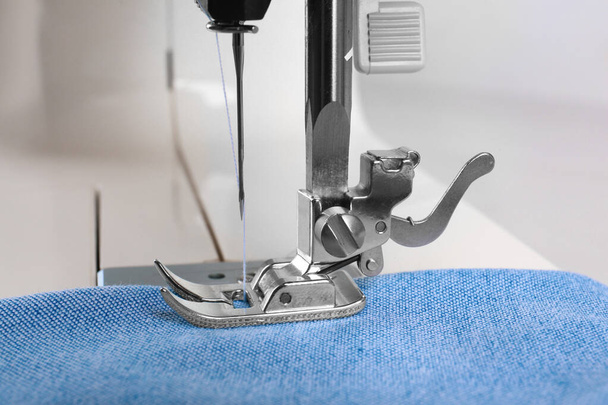 Sewing machine with light blue cloth, closeup - Foto, Bild