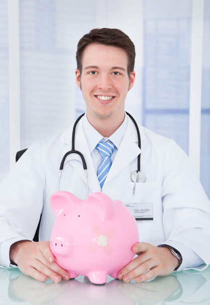 Doctor Examining Piggybank With Stethoscope - Photo, image