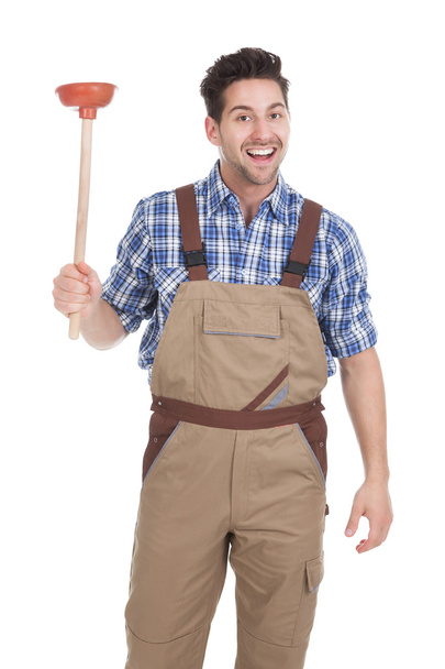 Excited Young Male Plumber Holding Plunger - Foto, afbeelding