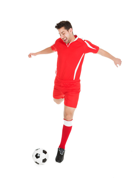 Soccer Player Kicking Football - 写真・画像