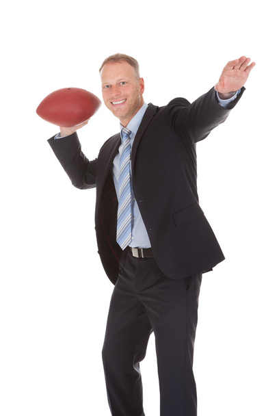 Businessman Throwing Rugby Ball - Foto, Imagen