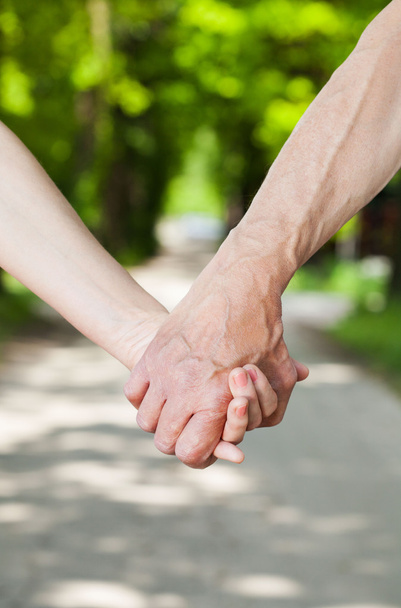 A couple holding hands  - Фото, изображение