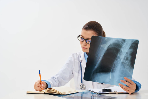 Doctor sits at the table x-ray picture radiologist research - Photo, image