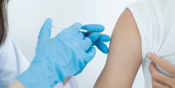 Γυναίκες γιατροί εμβολιασμένες με σύριγγες για την πρόληψη επιδημιών σε νοσοκομεία, υγειονομική περίθαλψη και ιατρικές έννοιες. - Φωτογραφία, εικόνα