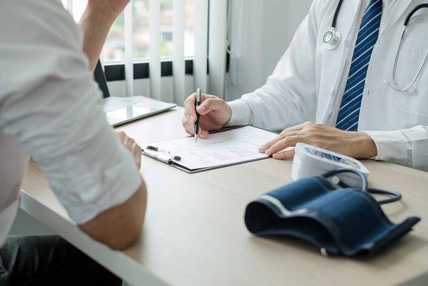 Man doctors explain and recommend treatment after a female patient meets a doctor and receives results regarding illness problems. Medical and health care concepts. - Photo, Image