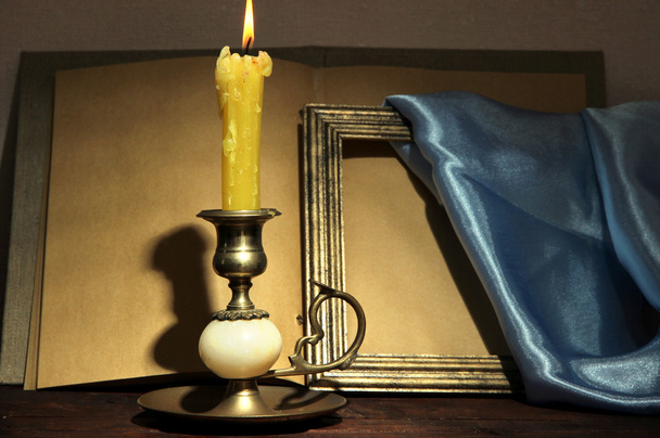 Old candle on table in room - Φωτογραφία, εικόνα