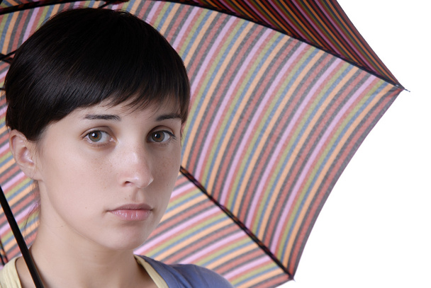 Young brunette girl with umbrella in colors - Photo, Image