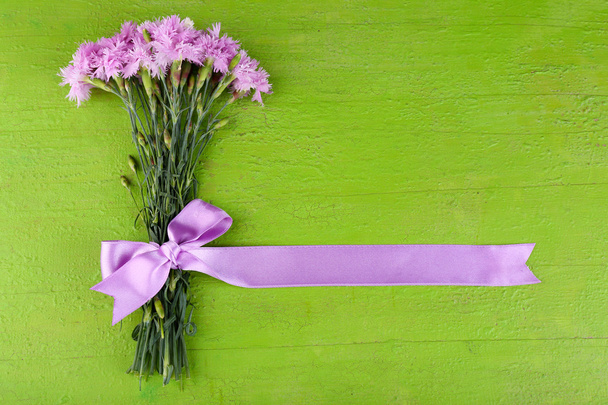 Beautiful bouquet with ribbon on wooden background - Фото, зображення