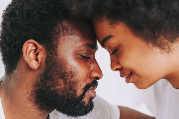 Afro american couple in bed - Real beautiful and cheerful pair of lovers at home - Fotó, kép