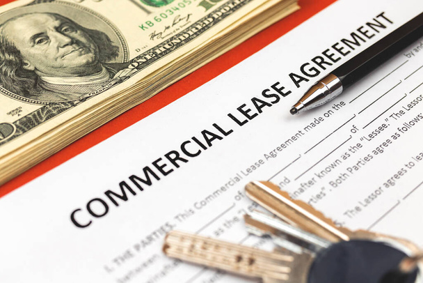 Commercial lease agreement form close-up. House keys, pen and money on office desk. Close-up photo - Photo, Image