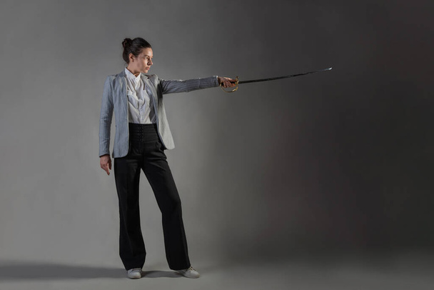A businesswoman in a business casual suit attacks competitors, - Fotó, kép