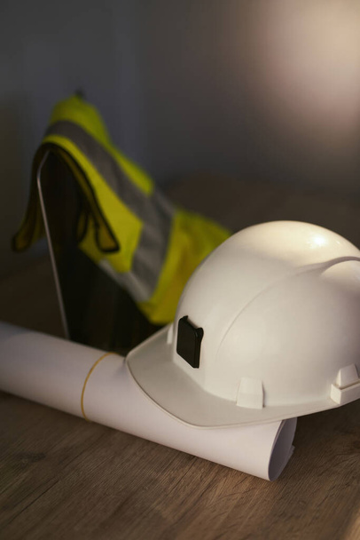 Construction: blueprints, hardhat, laptop and safety vest - Photo, Image
