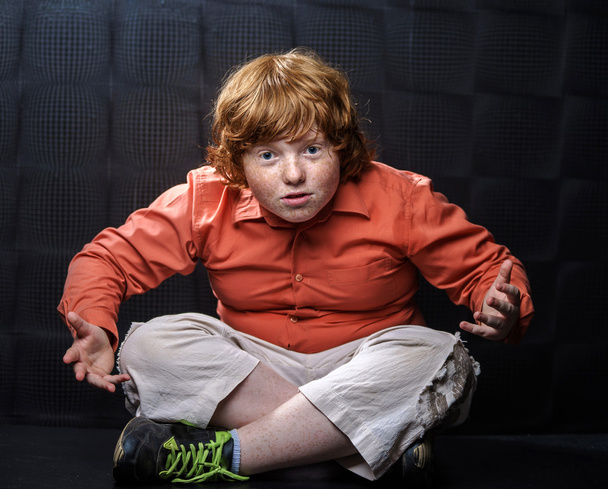 Freckled red-hair boy posing on dark background. - Φωτογραφία, εικόνα