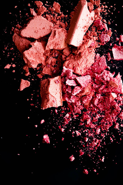 Crushed cosmetics, mineral organic eyeshadow, blush and cosmetic powder isolated on black background, makeup and beauty banner, flatlay design - Photo, Image