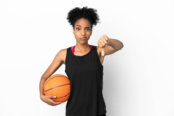 Young basketball player latin woman isolated on white background showing thumb down with negative expression - Photo, Image