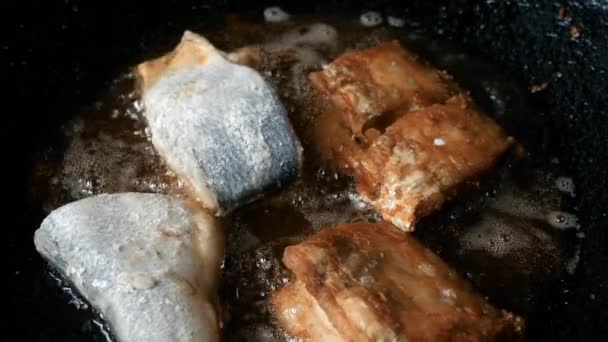 Closeup of frying fish filet in a pan in the medina of Marrakesh (Marrakech), Morocco. Street food, background footage. - Felvétel, videó